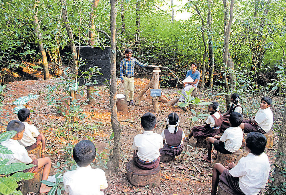 A learning session at Kalika Kaanu in Hudlamane village, Uttara Kannada district; (below)  Balachandra Hegde Sayimane and G M Naik at the entrance of the green school. PHOTOS BY AUTHOR
