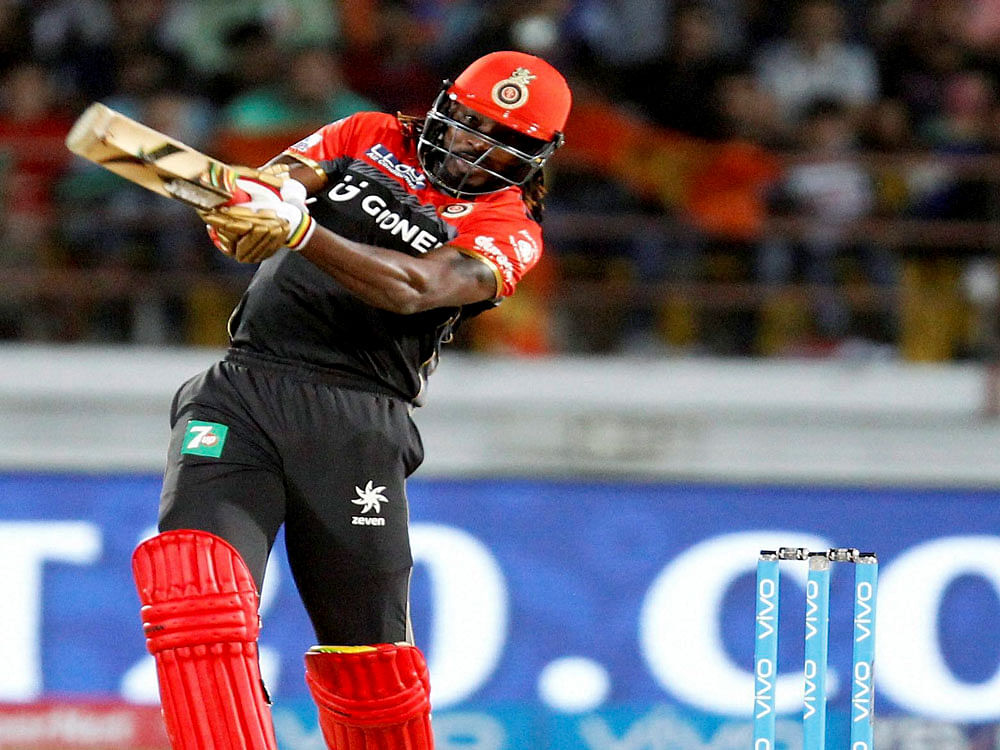 Royal Challengers Banglore batsman Chris Gayle plays a shot during the IPL T 20 match against Gujarat Lions in Rajkot on Tuesday. PTI Photo