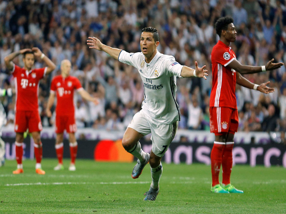 Real Madrid's Cristiano Ronaldo, center, celebrates after scoring as Bayern players react during the Champions League quarterfinal second leg soccer match between Real Madrid and Bayern Munich at Santiago Bernabeu stadium in Madrid, Spain. AP/PTI