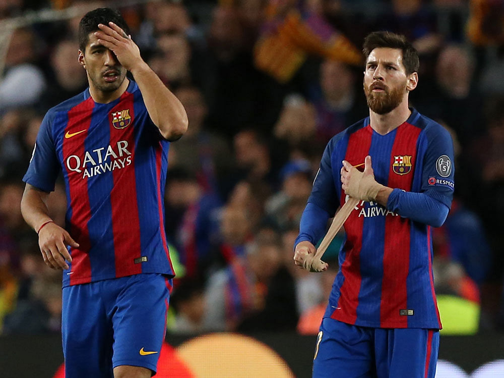 arcelona's Luis Suarez and Lionel Messi look dejected after the match. Reuters
