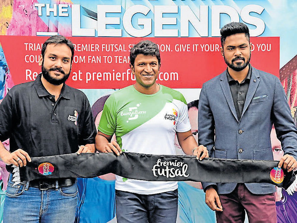 starry touch Actor Puneeth Rajkumar (centre) at the Premier Futsal Launchpad with Bangalore 5's co-owner Rajesh K R (left) and Premier Futsal managing director Dinesh Raj.