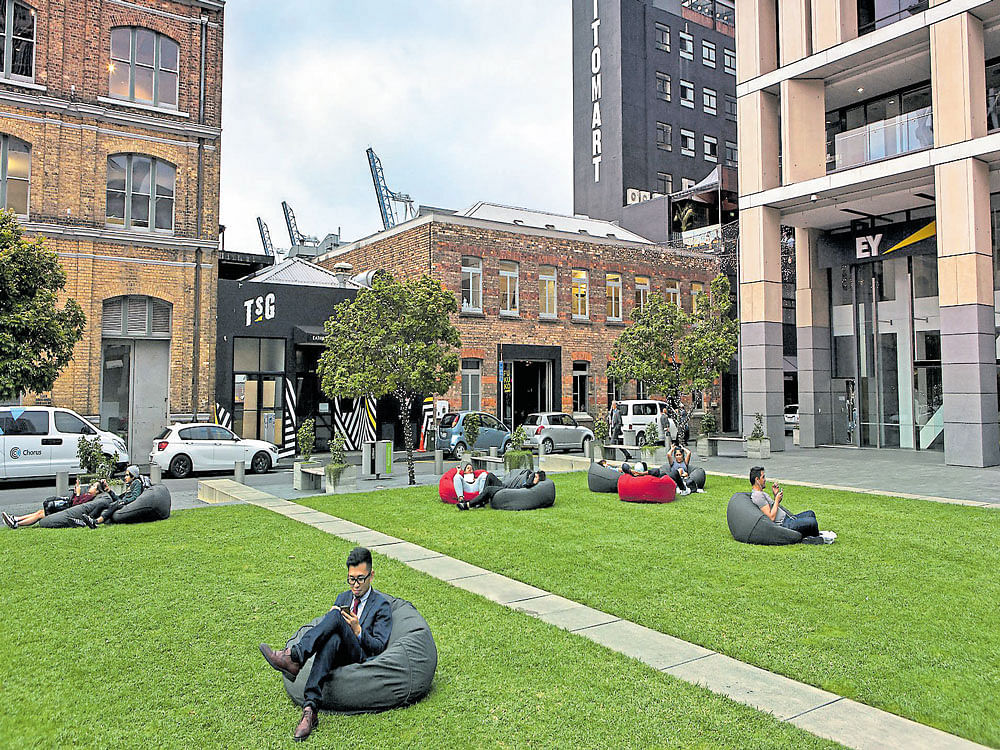 solitary haven: People relax on beanbag chairs in Takutai Square in downtown Auckland. At a moment of political upheaval across the globe, New Zealand's distance and isolation serves as a selling point to become the next technology hub. NYT