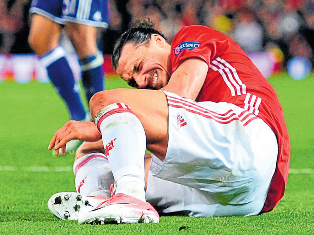 Big Blow Manchester United striker Zlatan Ibrahimovic writhes in pain after getting injured on Thursday. AFP