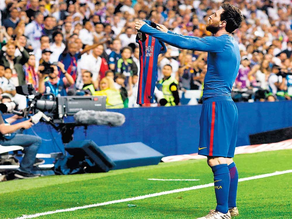 Man of the hour: Barcelona's Lionel Messi celebrates after scoring the winner against Real Madrid on Sunday. AFP