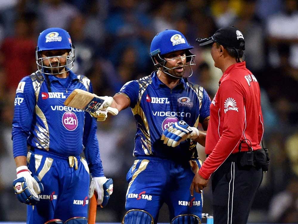out of line? Mumbai skipper Rohit Sharma in an animated discussion with umpire S Ravi on Monday. PTI