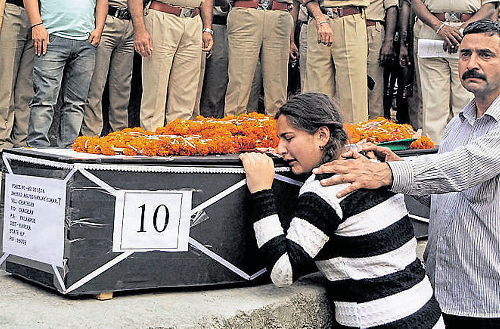 Daughter of CRPF martyr Sanjay Kumar, who was killed in a Maoist attack at Sukma in Chhattisgarh on Monday, wails near his body during his funeral at his native village Chechain Nagri near Dharamsala on Tuesday. PTI