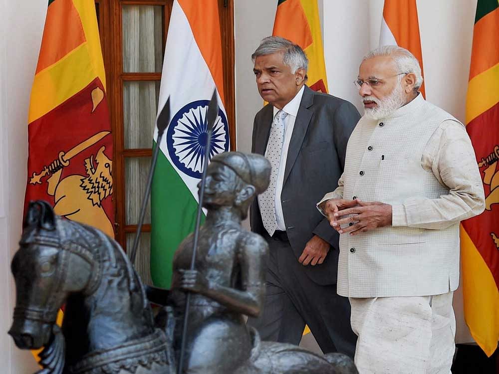 Prime Minister Narendra Modi with his Sri Lankan counterpart Ranil Wickremesinghe as they walk for their meeting at Hyderabad house in New Delhi on Wednesday.PTI Photo