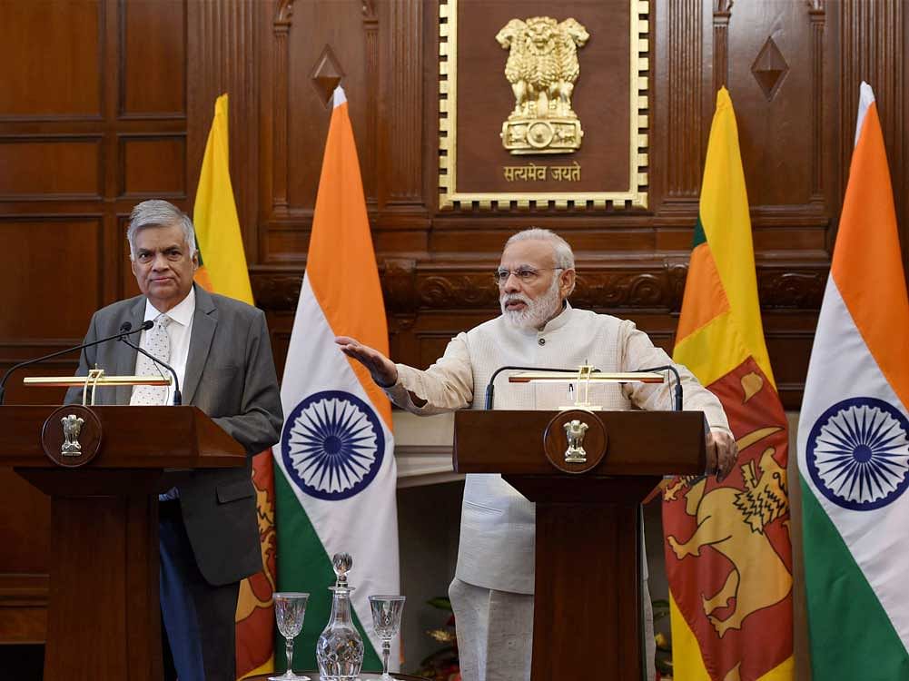 Prime Minister Narendra Modi with his Sri Lankan counterpart Ranil Wickremesinghe at the signing of an MoU between India and Sri Lanka on Cooperation in economic project at Hyderabad house in New Delhi on Wednesday. PTI Photo