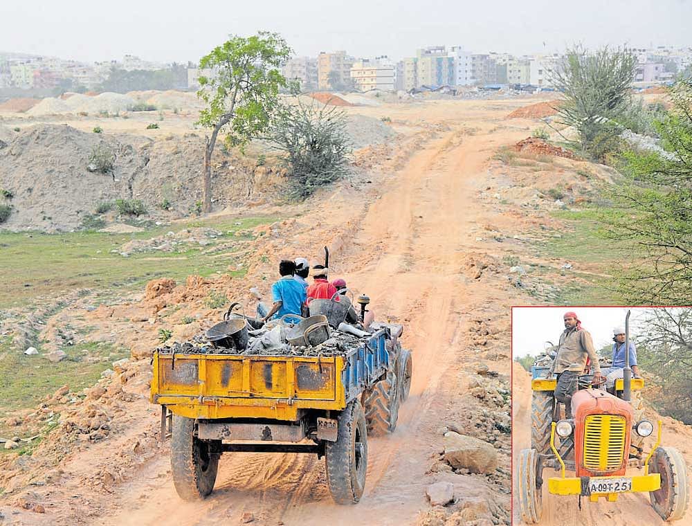 Futile vigil? A debris-laden tractor heads to the channel areas of Bellandur-Varthur lakes  on Wednesday. DH&#8200;Photos / Srikanta Sharma R