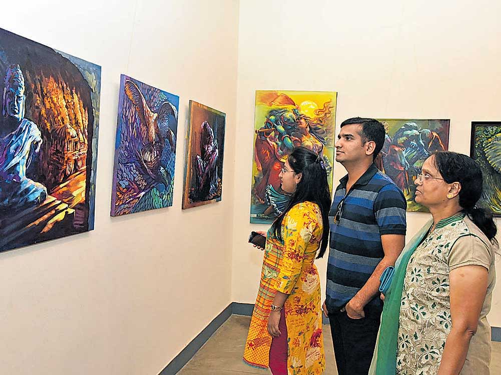 Visitors at 'Rainbow,' a national painting exhibition at Karnataka Chitrakala Parishath,  on Wednesday. dh photo