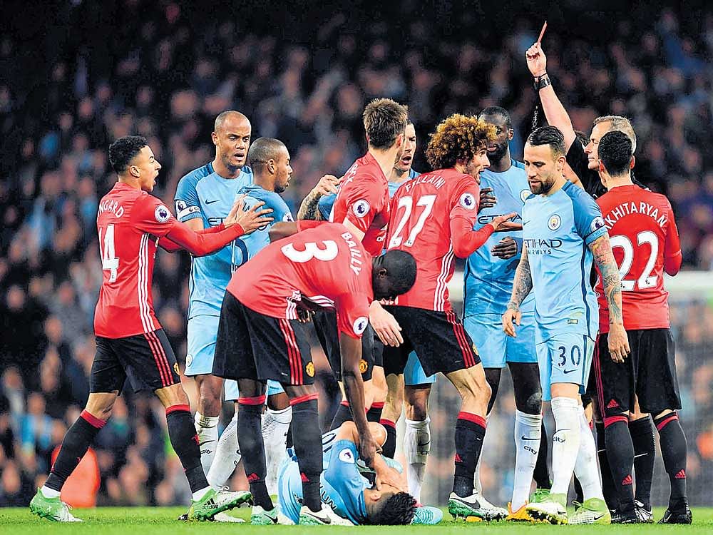 off you go: Manchester United's Marouane Fellaini (27) is given the marching orders after a head-butt on Sergio Aguero. AFP