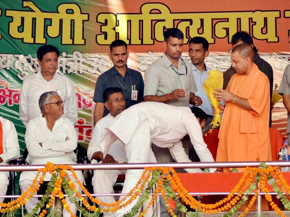MLA Amanmani Tripathi seeking blessing with Chief Minister Aditya Nath Yogi at a function in Gorakhpur on Saturday. PTI Photo