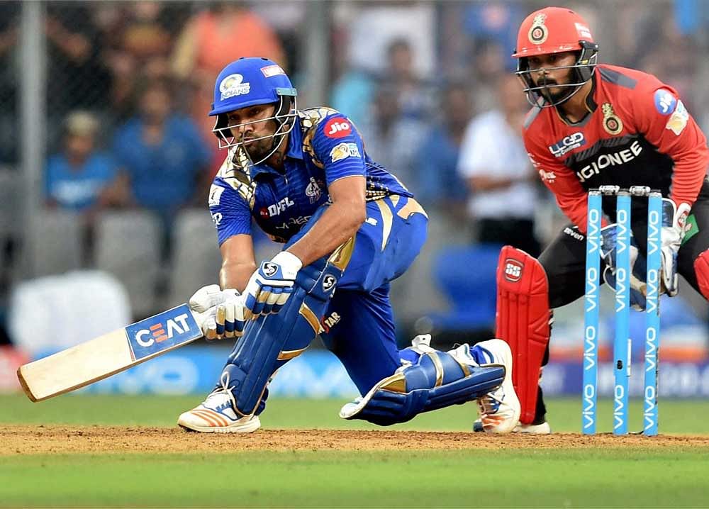 LEADING FROM the FRONT: Mumbai's Rohit Sharma sends one to the fence during his unbeaten knock of 56 against RCB. PTI