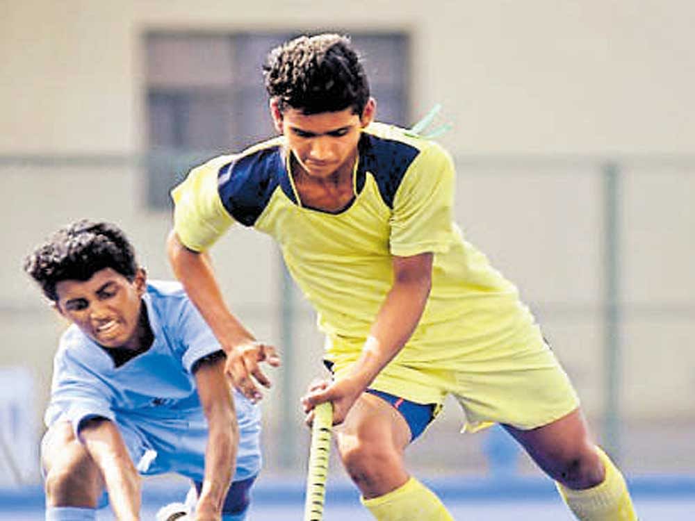 Hockey Rajasthan's Vijendra Singh Rathore (right) and Mohammed Suhaila of Hockey Kerala vie for the ball during their tie on Tuesday.