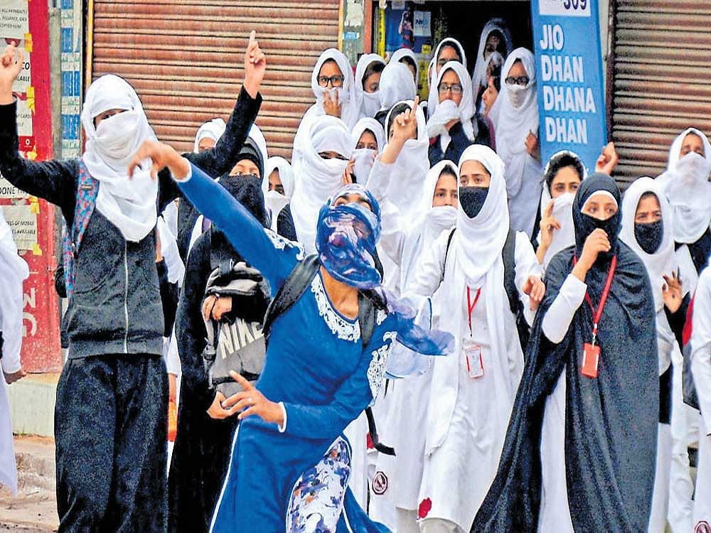 Girl students pelt stones at security personnel during clashes at Lal Chowk in Srinagar. Adding to the valley's volatility and India's worries, more reckless and alienated younger generation of local youth is now leading the anti-India protests. PTI