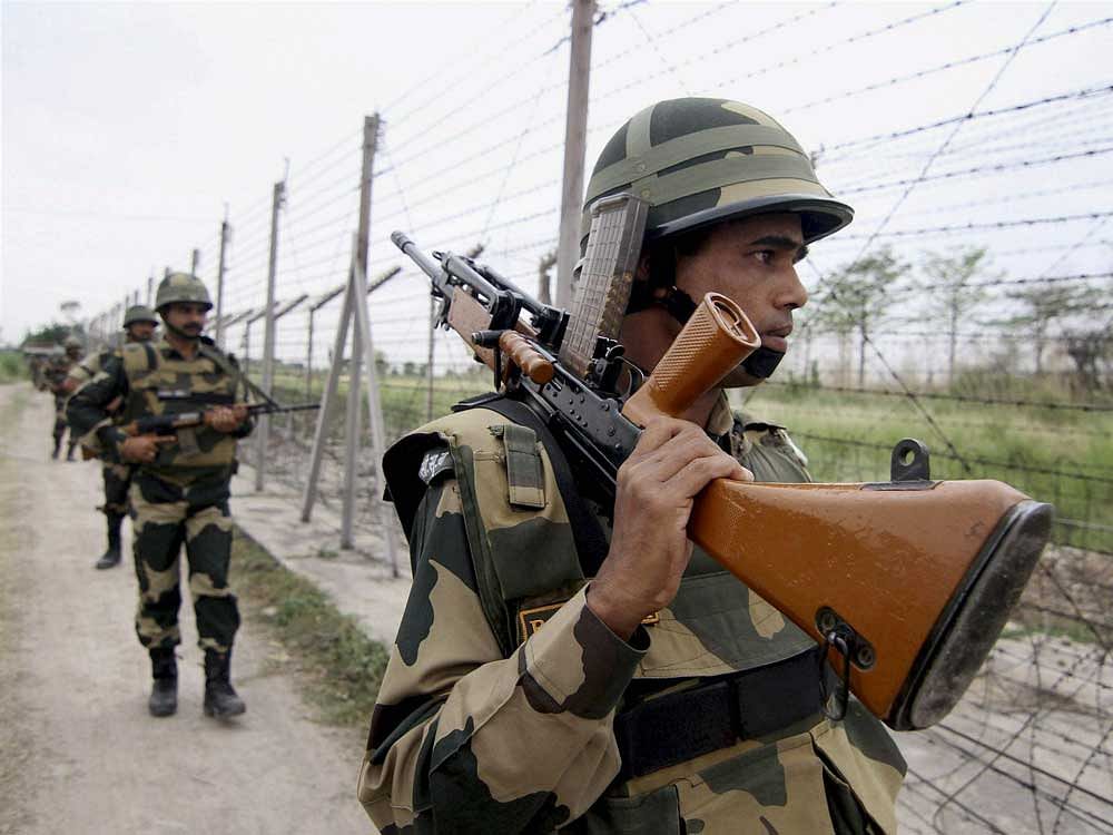 BSF personnel patrolling along the international border on Wednesday. PTI