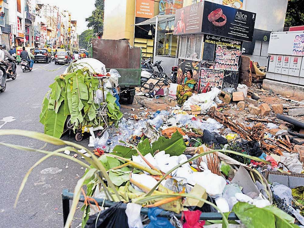 Bengaluru is yet to find a solution to dumping of garbage in public places. Picture shows a dirty Dispensary Road in the heart of the city. DH FILE PHOTO