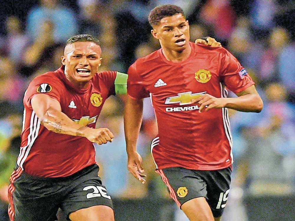 Manchester United's Marcus Rashford (right) celebrates with team-mate Antonio Valencia after scoring his side's only goal against Celta Vigo on Thursday. AFP