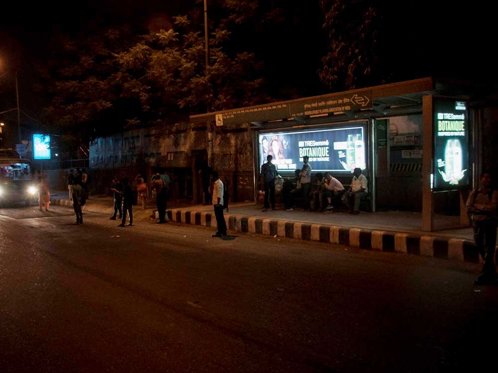 Commuters at the ill-fated Munirka bus-stop in New Delhi on Saturday. A 23-year-old paramedical student boarded the private bus from here in which she was raped by six men on 16 December, 2012. PTI Photo