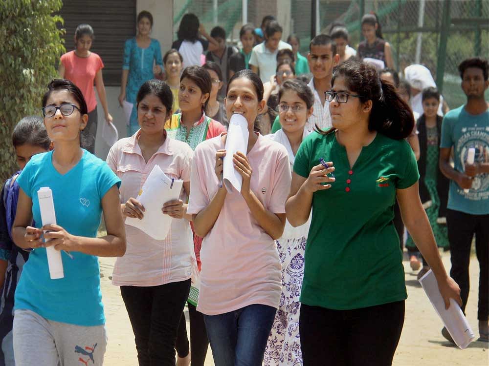 Students coming out after taking the 'National Eligibility Entrance Test (NEET) in Gurugram on Sunday. PTI Photo