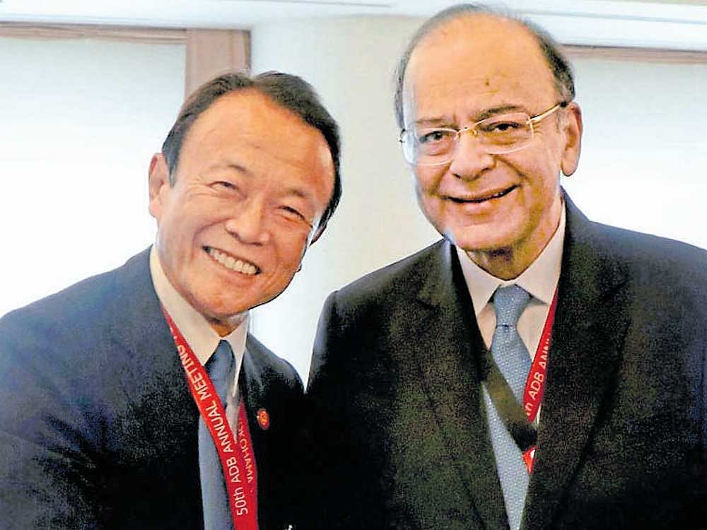 Finance Minister Arun Jaitley (left) greets his Japanese  counterpart Taro Aso on the sidelines of the annual ADB Board of Governors meeting in Yokohama on Sunday. PTI