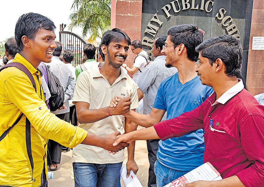 Candidates greet each other after taking NEET at Army Public School on Sunday. dh photo