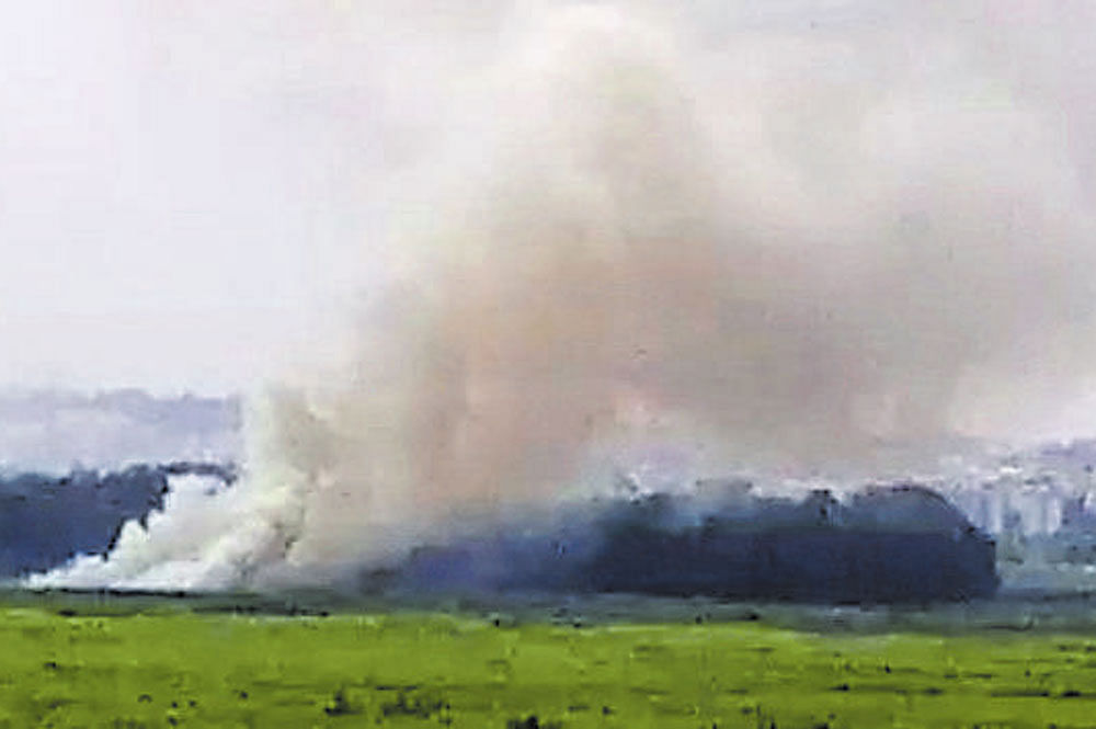 Smoke rises from Bellandur lake following a fire on Sunday.