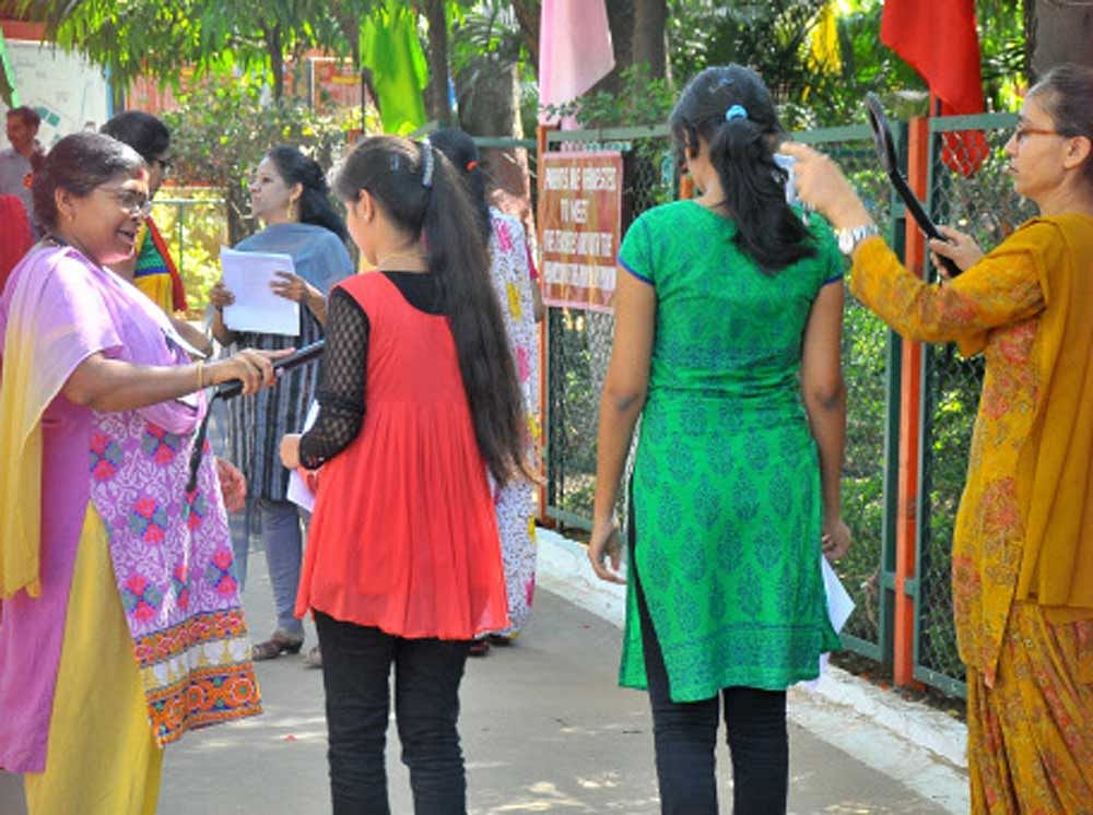 At many of the examination centres in different parts of the country, boys were made to cut the sleeves of their shirts while the girls had to remove their ornaments like nose pin and ear rings before they enter the examination hall. DH file photo