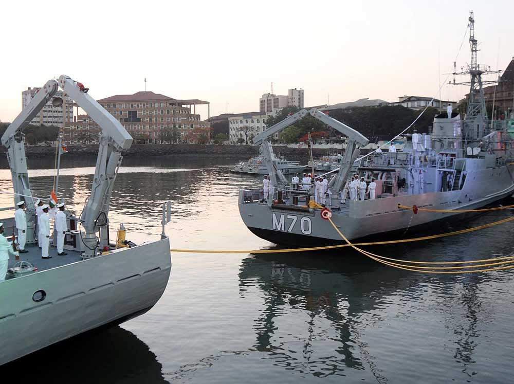 Flags are lowered for one last time from the ships - INS Karwar and INS Kakinada. DH PHoto