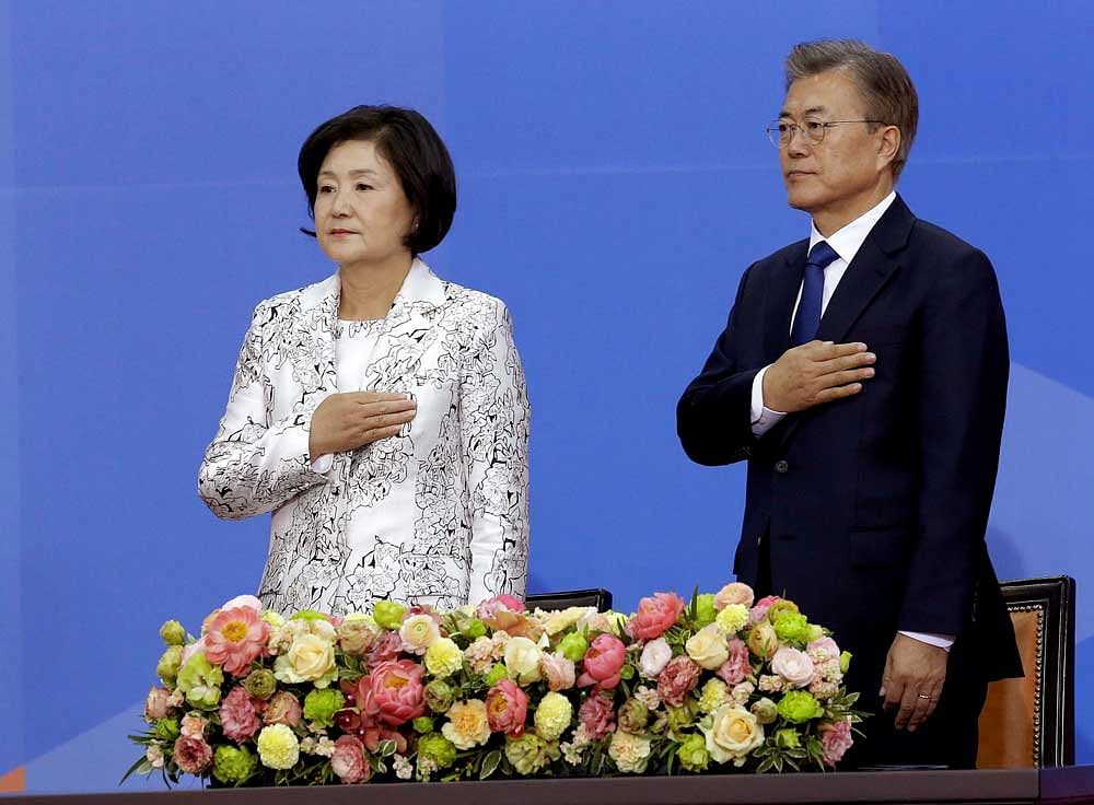 Newly elected South Korean President Moon Jae-in, right, and his wife Kim Jung-suk salute to a national flag during his inauguration ceremony at the National Assembly in Seoul, South Korea, Wednesday, May 10, 2017. AP/PTI