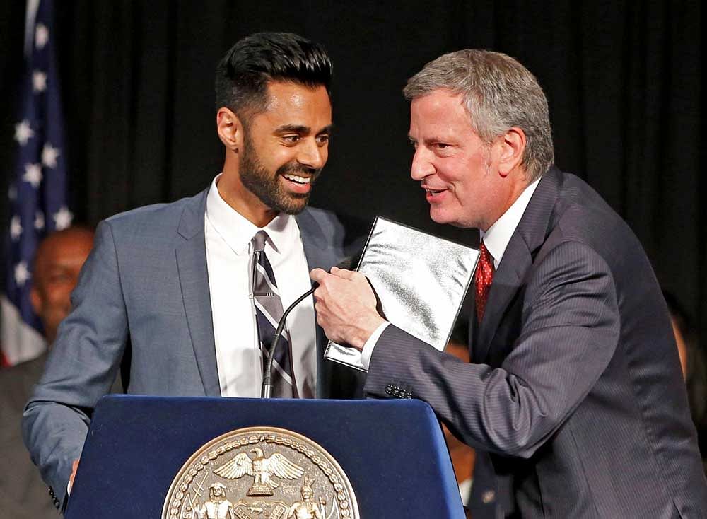 New York Mayor Bill de Blasio, right, takes the microphone momentarily as comedian Hasan Minhaj was speaking during the Asian-Pacific Heritage reception at Gracie Mansion in New York on Wednesday, May 10, 2017. De Blasio honored Minhaj at the reception, who recently performed at the White House Correspondents Dinner. AP/PT