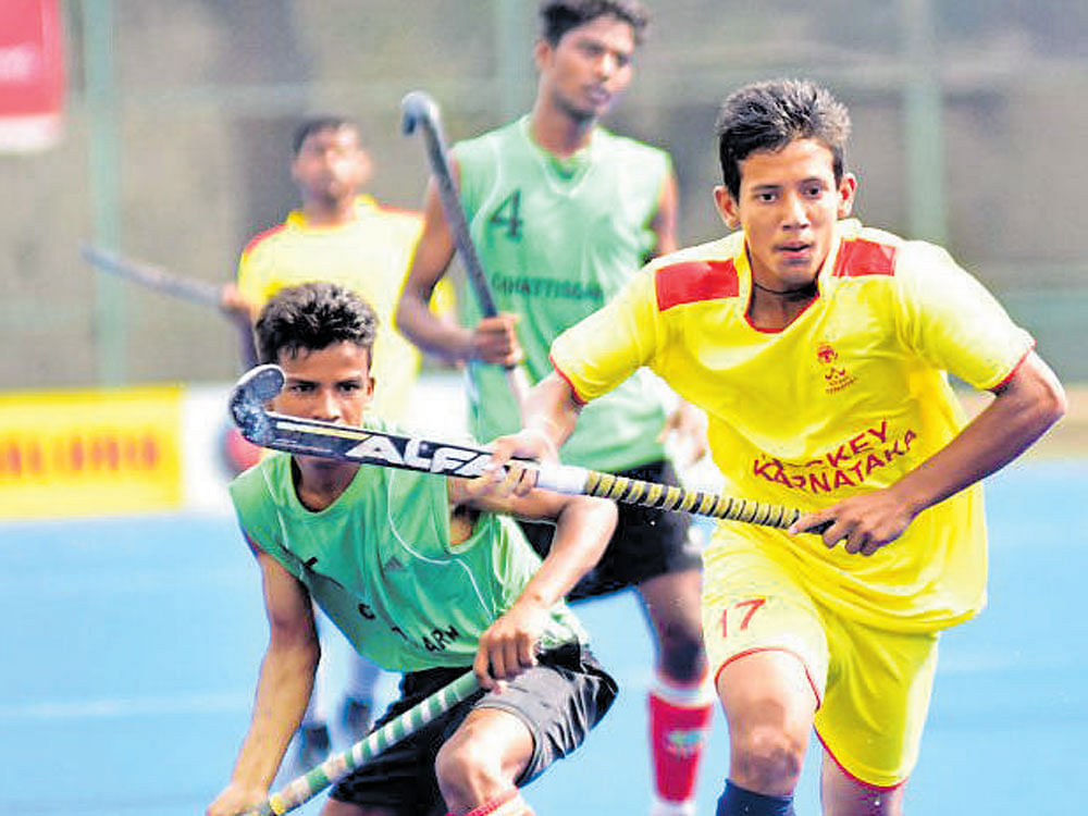 Out of my way! Manjeet (right)&#8200;of Karnataka dribbles past Arjun Yadav of Chhattisgarh during their clash in the Sub-junior Nationals ('A' Division) on Thursday. DH Photo