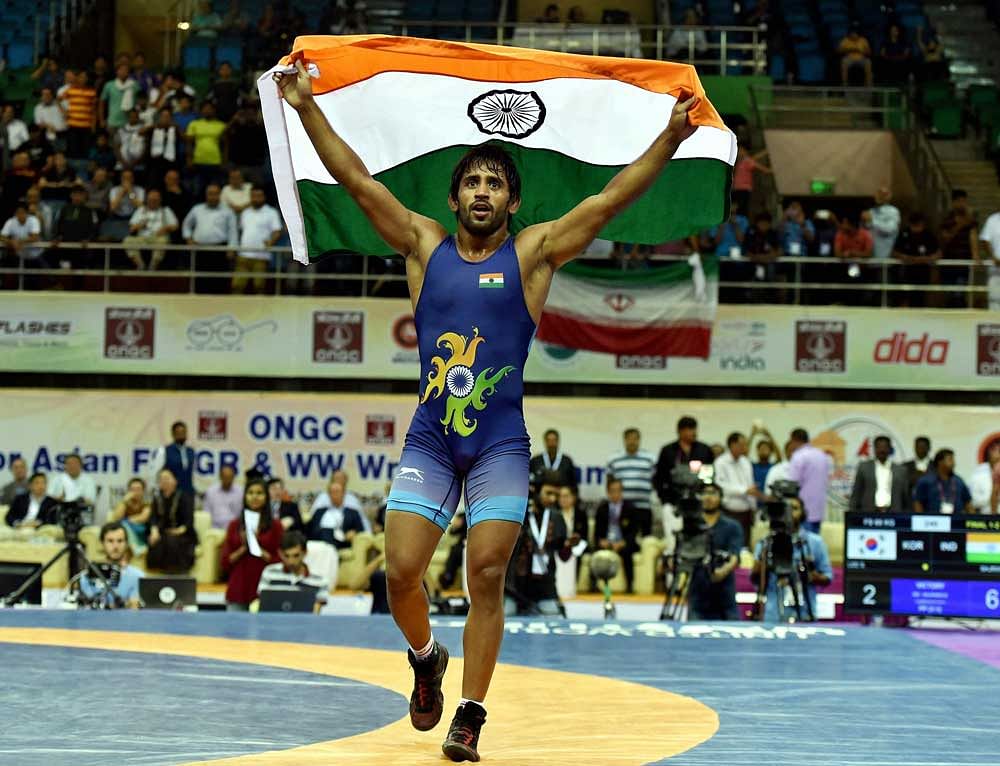 Indian wrestler Bajrang Punia celebrates after winning gold at Asian Wrestling Championship at I G Stadium in New Delhi on Saturday. Photo credit: PTI