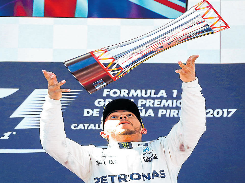 Battler: Lewis Hamilton celebrates his victory at the Spanish Grand Prix in Barcelona on Sunday. AFP