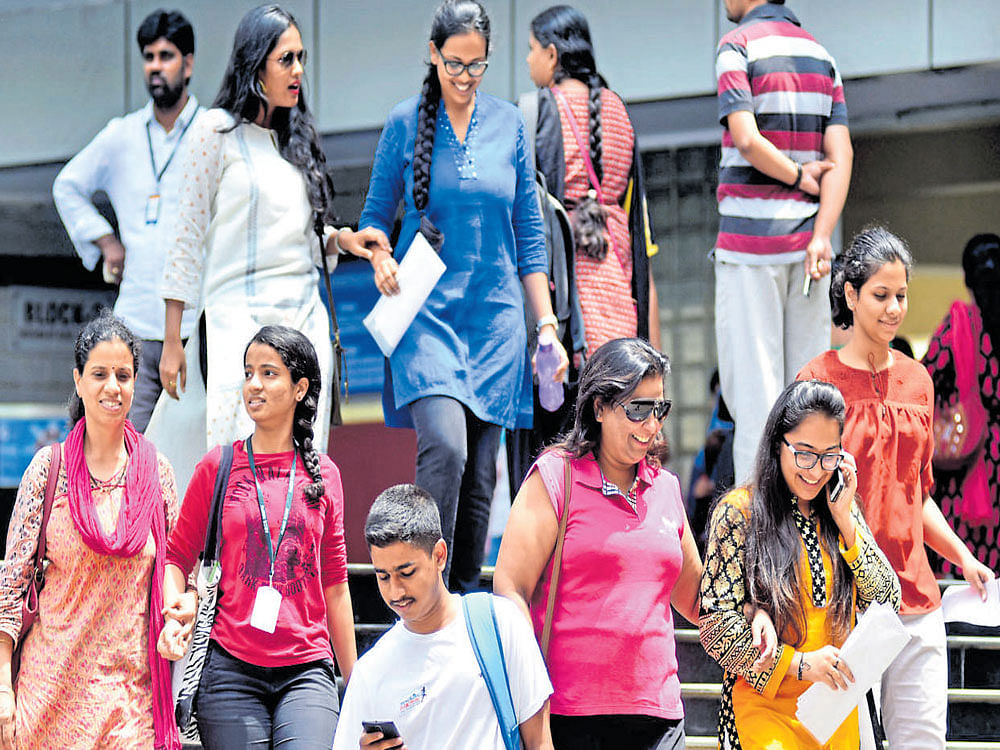 Students come out of MS Ramaiah College in Bengaluru, along with their parents, after taking the COMEDK undergraduate entrance test on Sunday. DH Photo