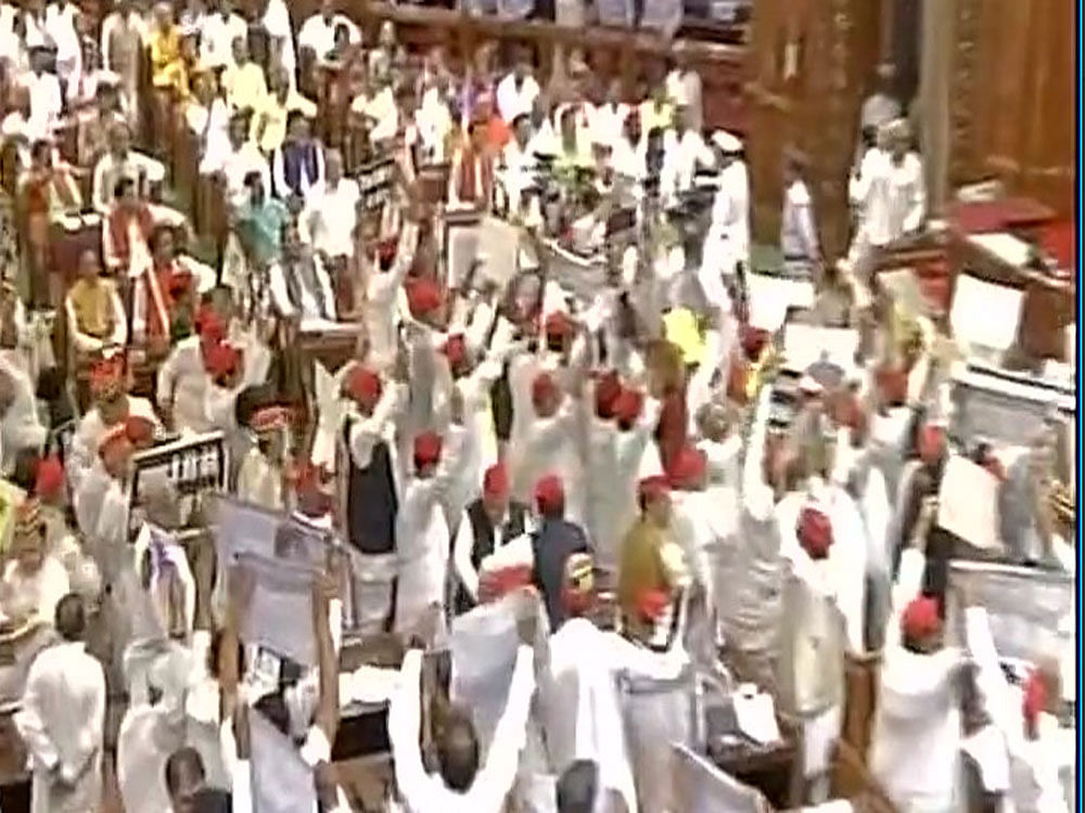 Slogan-shouting opposition members trooped into the Well despite Speaker Hridaya Narain Dixit's appeal at an all-party meeting to ensure smooth proceedings. Photo courtesy ANI.