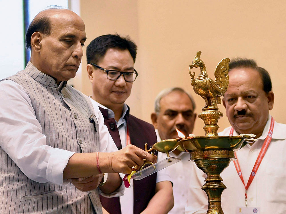 Union Home Minister Rajnath Singh with Union Minister for Science and Technology and Earth Sciences Harsh Vardhan and Minister of State for Home Kiren Rijiju at the lamp lighting ceremony of the National Platform for Disaster Risk Reduction's (NPDRR) second meeting at Vigyan Bhawan in New Delhi on Monday. PTI Photo.