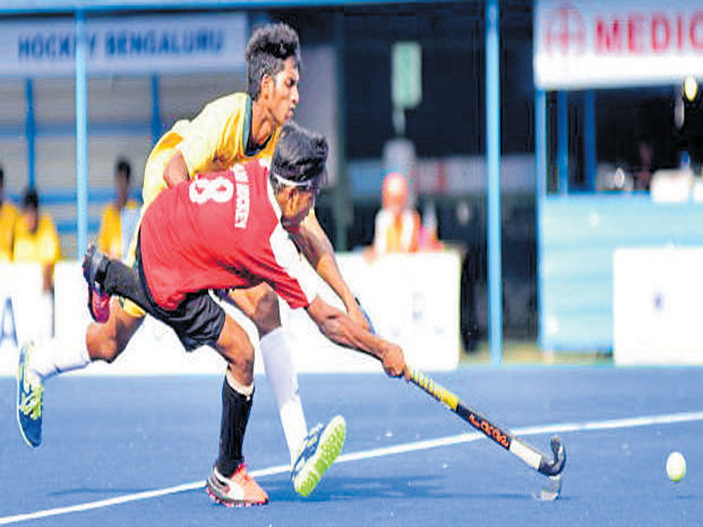 Keen tussle: Rohit (front) of Delhi Hockey attempts to get past a Hockey Jharkhand player on Sunday. DH photo