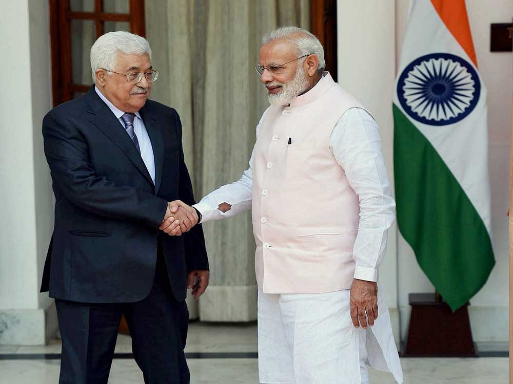 Prime Minister Narendra Modi shakes hands with Palestinian President Mahmoud Abbas before their meeting at the Hyderabad House in New Delhi on Tuesday. PTI Photo