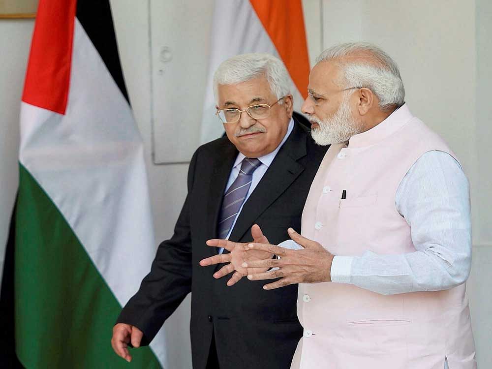 Prime Minister Narendra Modi talks to Palestinian President Mahmoud Abbas before their meeting at the Hyderabad House in New Delhi on Tuesday. PTI