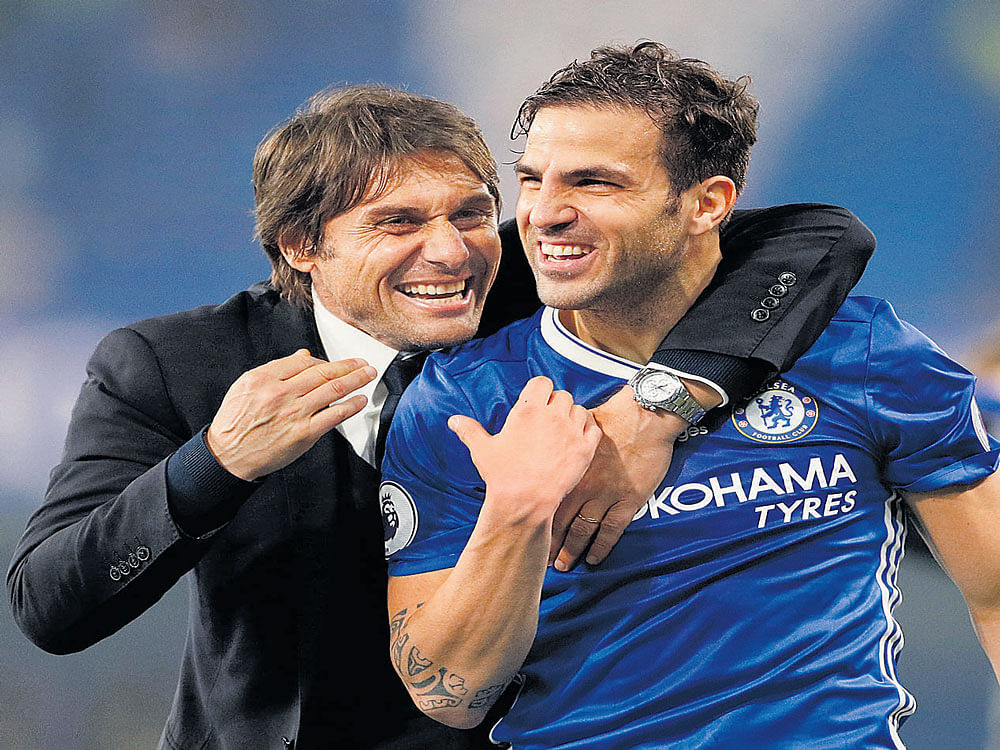 That was cool: Chelsea's manager Antonio Conte (left)&#8200;celebrates with Cesc Fabregas  after their win over Watford. Reuters