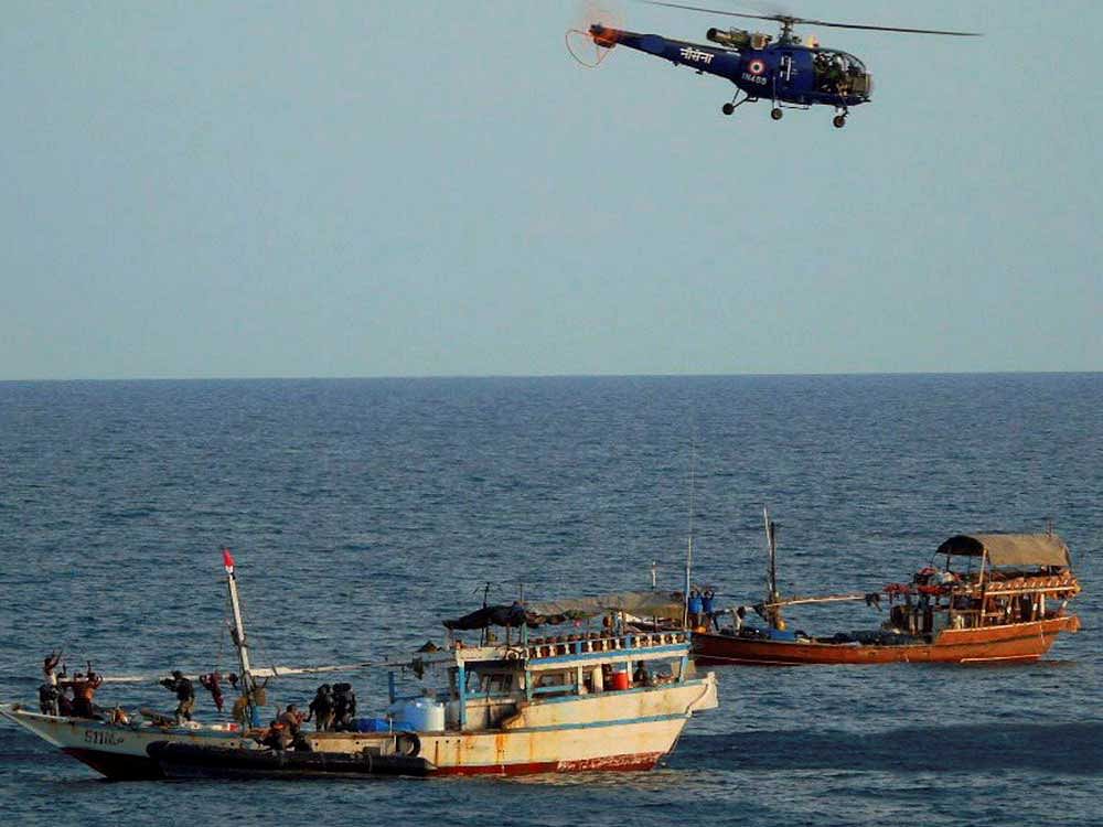An Indian Navy chopper in action to thwart a piracy attempt on a Liberian vessel in the Gulf of Aden on Tuesday. PTI Photo