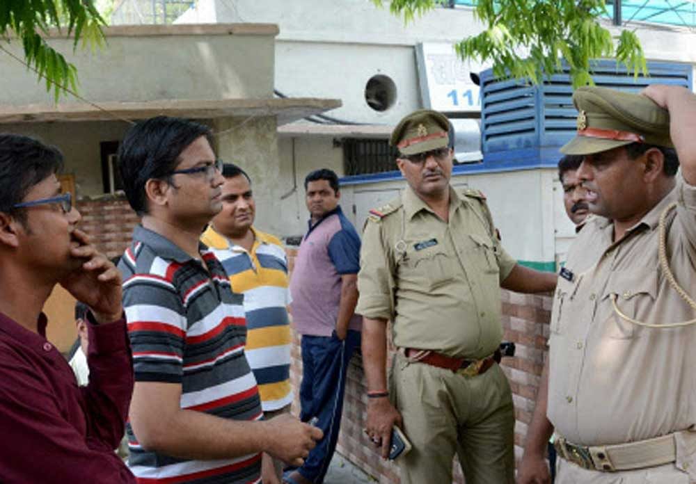 Family members of Karnataka Cadre IAS officer Anurag Tewari wait outside a morgue to receive his body in Lucknow on Wednesday. Tewari was found dead under misterious conditions. PTI Photo