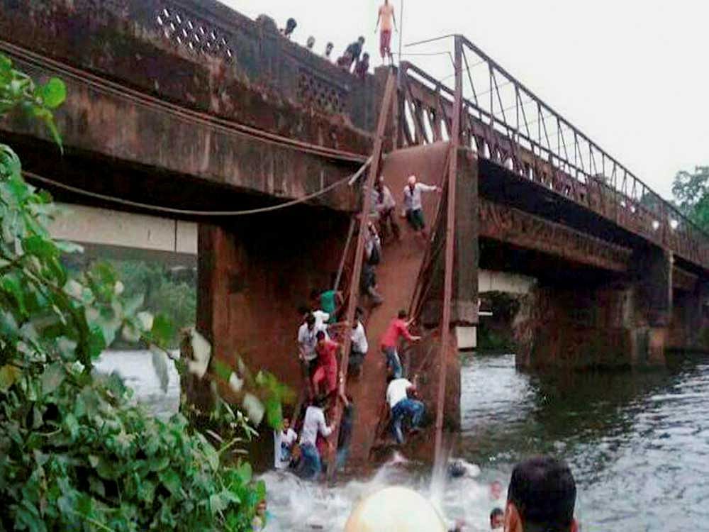 Rescue and relief works in progress after the Sanvardem Bridge collapsed in Curchorem, South Goa on Thursday. PTI Photo
