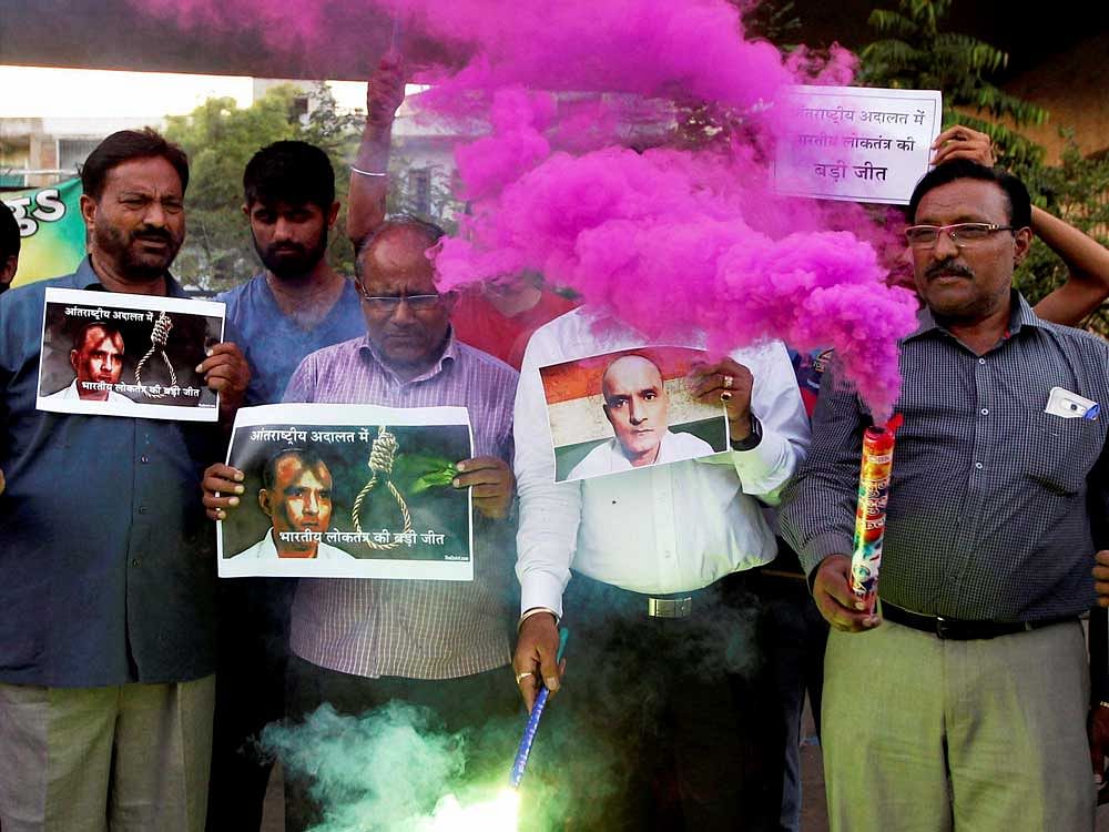 People celebrate with crackers the ICJ verdict on Kulbhushan Jadhav in Ahmedabad on Thursday. PTI Photo