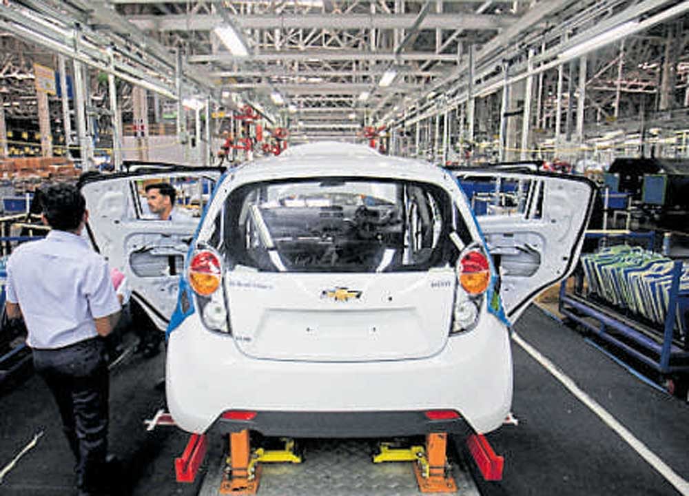 GM employees work on a Chevrolet Beat car on an  assembly line at the  company's plant in Talegaon. Reuters