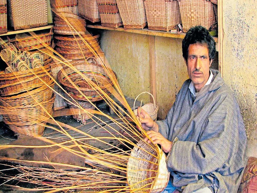 A man making baskets from willow rushes in Kashmir.