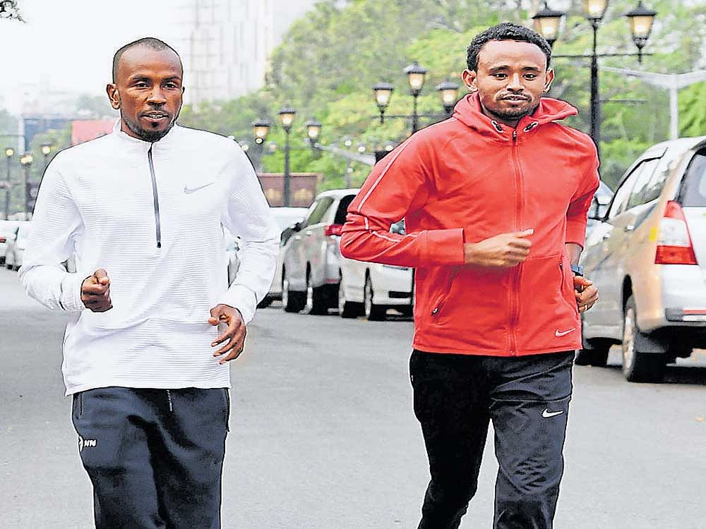 Defending champion Mosinet Geremew (right) of Ethiopia and Mumin Gala of Djibouti on a training run on the eve of the World 10K. DH PHOTO/ Kishor Kumar Bolar