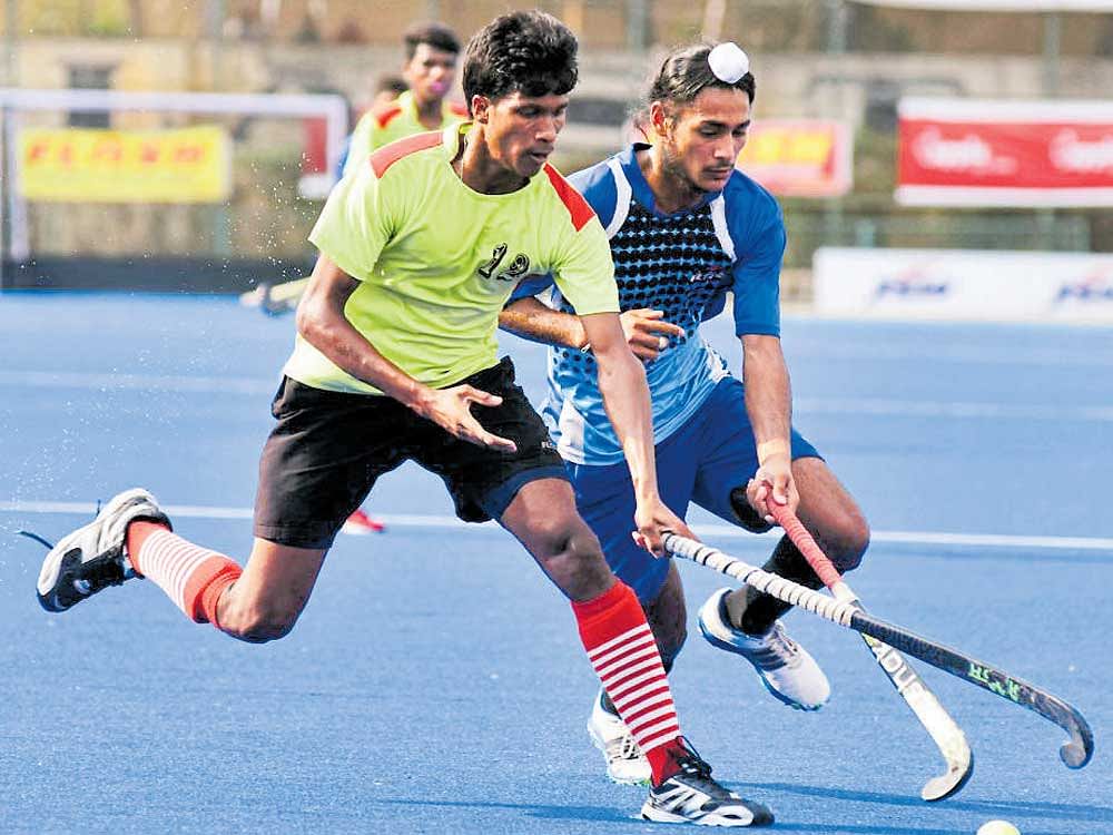 Illias Surin of Odisha (left) tries to steal the ball from Maninder Singh of Chandigarh. DH PHOTO