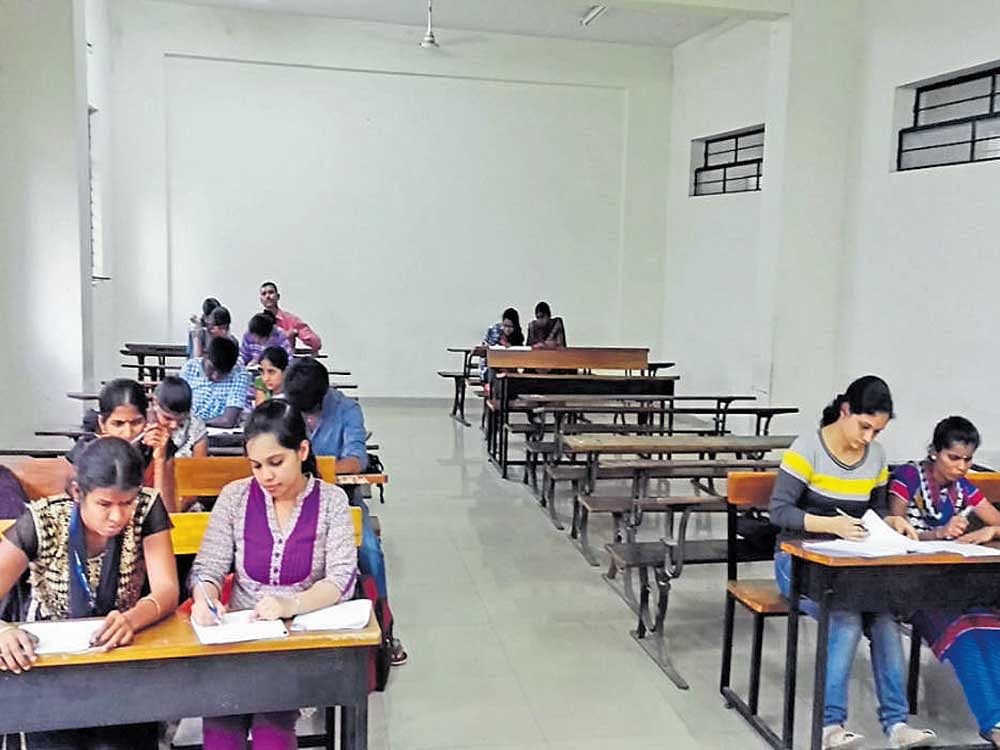 Scribes lend a helping hand literally for visually impaired students during an exam.